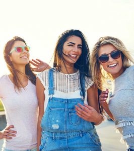 Three multiracial women smiling after Vaginal Rejuvenation in NYC, Manhattan, Brooklyn, Greenwich, CT, Manhasset, and Ridgefield, NJ