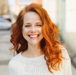 Woman with Red Hair Smiling After Vaginal Prolapse Surgery in Ridgefield, NJ, Greenwich, CT, Brooklyn, Manhasset, Manhattan, NY